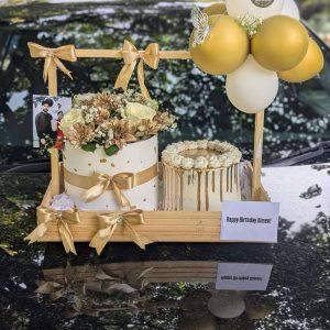 Golden wooden gift basket with cake, flower box and balloon by The LuvBox PK – gift shop in Islamabad