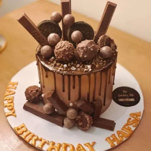 Luxury chocolate cake topped with KitKat, Dairy Milk, and Ferrero – best chocolate cake in Islamabad by The LuvBox Pk.