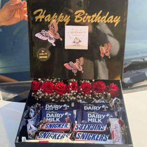 Black acrylic box by The LuvBox PK with red roses, chocolates, and custom golden message – luxury gift box in Islamabad