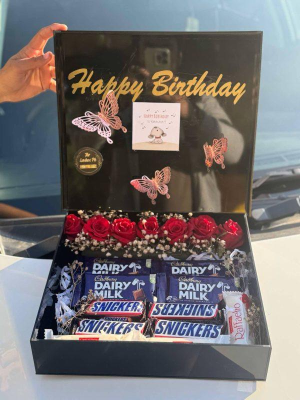 Black acrylic box by The LuvBox PK with red roses, chocolates, and custom golden message – luxury gift box in Islamabad