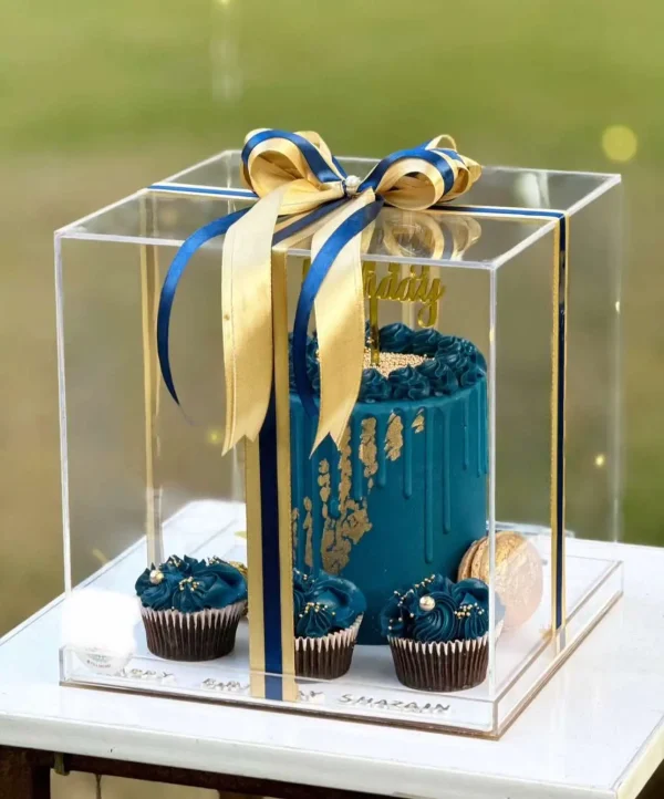 Luxury blue fondant birthday cake with cupcakes in acrylic LED box – customized cake delivery in Islamabad.